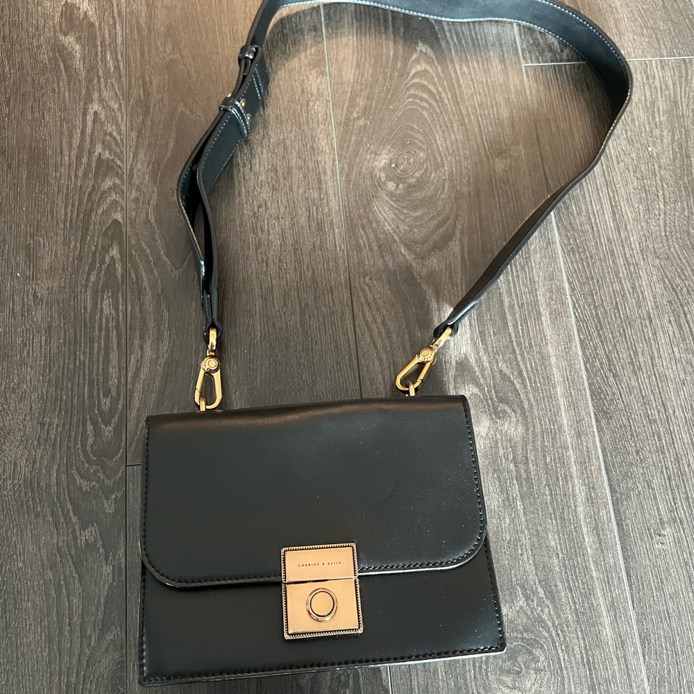 Charles & Keith Black and Gold Crossbody Bag with Flap Closure